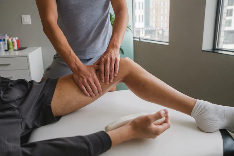 Hands-on treatment around a patient’s knee.