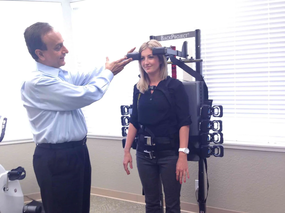 A patient working with Hiten Davé using BackProject therapy equipment