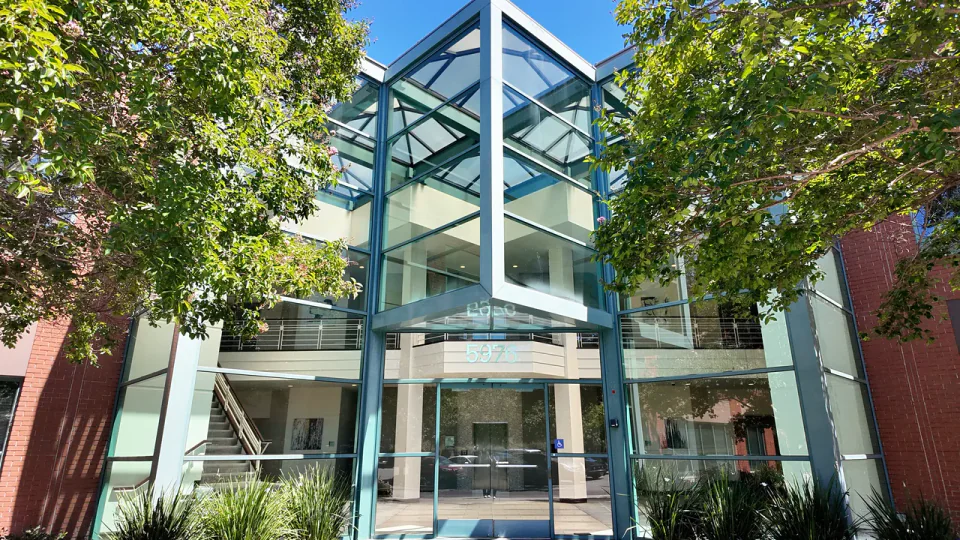 Glass-front entrance marked 5976 on West Las Positas Boulevard